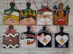 christmas ornaments are hanging on a wooden wall with snowman, santa clause and penguin