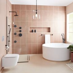 a bath room with a toilet a tub and a shower head mounted to the wall