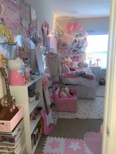 a room filled with lots of pink furniture and decor on the walls, including a guitar