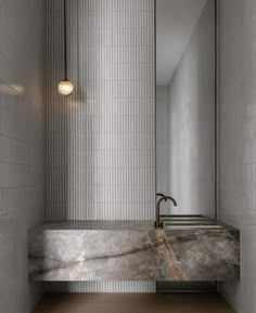 a bathroom with a marble sink and mirror