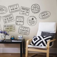 a chair and table in front of a wall with stamps on it