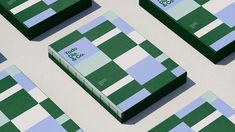 several green and blue business cards laid out on top of each other with the same design