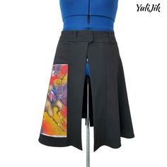 Original black warrior art skirt with front opening, reworked design, colorful abstract warrior shooting arrows art, hand painted. Changing your style on the go has never been easier. With just one button, you can effortlessly slip into this transformative skirt, embracing a new aesthetic with every wear. Whether you're headed to a gallery opening, a music festival, or simply strolling through the city streets, this skirt empowers you to express your individuality and embody the essence of a true warrior. The colorful artwork on this skirt pays homage to the strength and resilience of a warrior spirit.  The black evokes a sense of power and mystery, while the unique reworked wrap design ensures an effortless and comfortable fit. Size: 8 Waist - 34" Length - 24" Polyester, rayon, spandex bl Black Warrior Art, Changing Your Style, Warrior Painting, Open Front Skirt, Black Warrior, Arrow Art, Gallery Opening, Warrior Art, Skirt Patterns