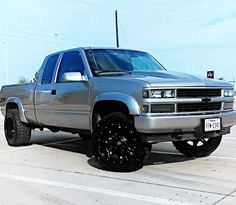 a silver truck parked in a parking lot