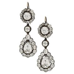 A magnificent pair of Georgian diamond drop earrings c.1800, each earring set to the top with an old European brilliant cut diamond in a cut down collet setting surrounded by a frame of smaller old cut brilliants, beneath which is a single diamond in a finely articulated mount, suspending a drop formed of an old cut pear shaped diamond surrounded by a frame of smaller old cut brilliants, all in cut down collet settings in silver, with gold hook earring fittings. These showstopper earrings have s Antique Jewelry Drop Earrings With Historical Design, Victorian Diamond Earrings, Ornate Historical Design Drop Earrings Jewelry, Victorian Drop Diamond Earrings, Antique Historical Drop Earrings, Antique Diamond Earrings, Georgian Jewelry, Diamond Drop Earrings, Diamond Drops