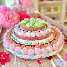 there is a cake that has been decorated with candy and marshmallows on it