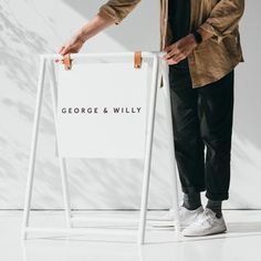 a man standing next to a sign that says george and willy