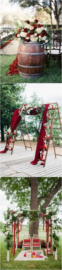 an outdoor ceremony setup with red and white flowers on the trees, benches and tables