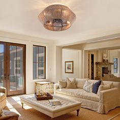 a living room filled with furniture and lots of windows