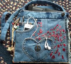 a cell phone and headphones in a jean purse