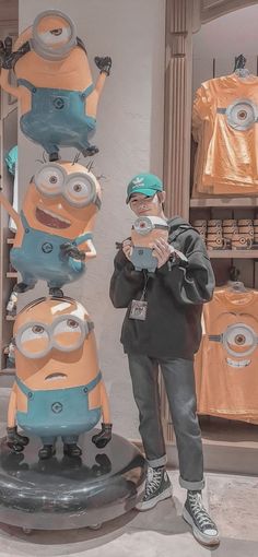 a man standing in front of a display of minion figures