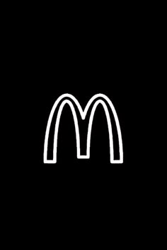 a black and white image of a mcdonald's logo on a dark background,