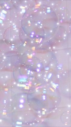 soap bubbles floating in the air on a tiled floor with stars and sparkles around them