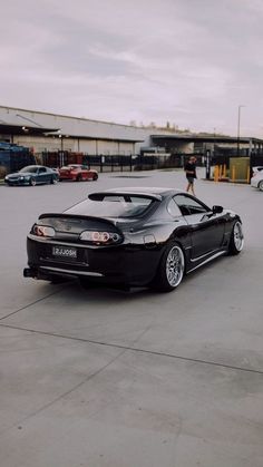 a black sports car parked in a parking lot