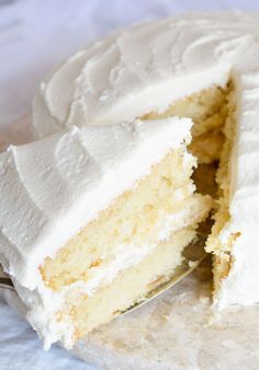 a close up of a cake with white frosting