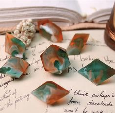 several pieces of glass sitting on top of an open book