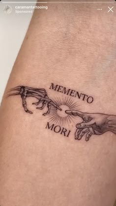 a tattoo with two hands holding each other and the words mementoo mor on it