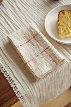 a piece of cake sitting on top of a table next to a white plate and napkin