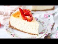 a slice of cheesecake with strawberries on top is sitting on a floral plate