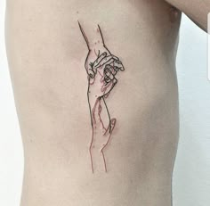 two hands holding each other on the side of a woman's stomach with red ink