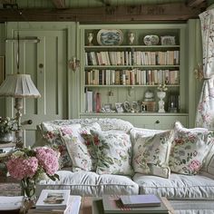 a living room filled with furniture and lots of books