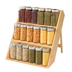 a wooden spice rack filled with lots of different kinds of beans and spices on top of each other