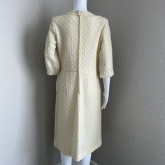 Vintage Adrian TabinUS Vintage Women's Size 16 (This is not a modern day size 16, please see the measurements below, it is smaller than modern 16)The detail work on this vintage mohair and wool dress is gorgeous. The overlay is made of a light yellow/ivory fine crochet texture with boucle detail at the collar and wrist. It has an ivory colored Talon brand zipper down the back. It is lined with an ivory acetate fabric. The sleeves are not quite 3/4 length. There is a belt loop on one side but it is missing on the other. I have left it as it was so you can decide what to do with it. This is a fairly conservative style with the crewneck line. I could see someone wearing this with a pillbox hat and some gloves. It is in very good vintage condition. Please see pictures for details and material Classic Cream Dress For Vintage Events, Cream Vintage Midi Dress, Cream Knee-length Vintage Dress, Beige Fitted Vintage Dress For Formal Occasions, Formal Fitted Beige Vintage Dress, Cream Fitted Dress For Vintage Fashion, Cream Fitted Dress For Vintage Style, Fitted Cream Dress For Vintage Fashion, Cream Fitted Long Sleeve Vintage Dress