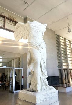 a large white statue in the middle of a room