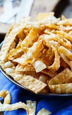 a plate full of cheesy crackers on a blue cloth