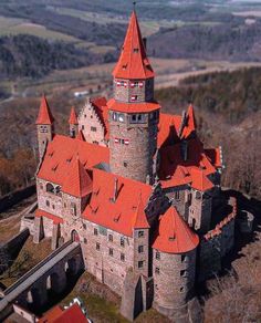 an aerial view of a castle with red roofs