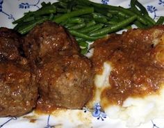 meatballs and mashed potatoes on a plate with green beans