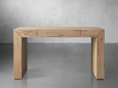 a wooden table sitting on top of a cement floor