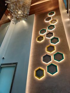 an elegant hallway with hexagonal lights and chandelier