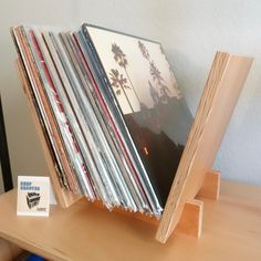 a stack of records sitting on top of a wooden table