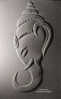 an elephant head with a crown on it's head is drawn in white paper