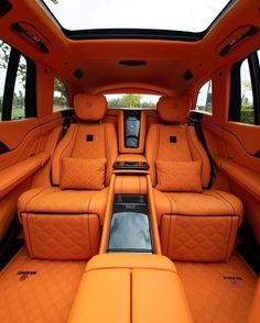 the inside of an orange car with leather seats