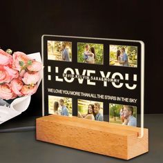 a photo frame with flowers and a bouquet of roses in front of it that says i love you