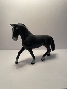 a toy horse is shown on a white surface