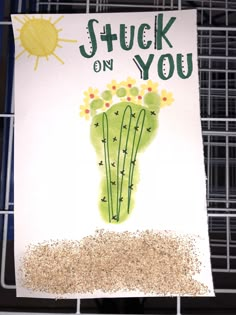 a card that says stuck on you with a cactus in the sand next to it