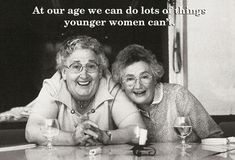 two older women laying on the table with wine glasses