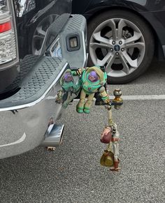 a small toy elephant standing next to a car