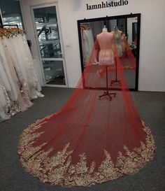 a mannequin in front of a dress on display at a bridal shop