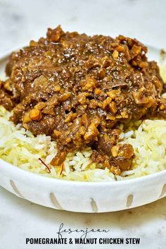 a white bowl filled with rice and meat