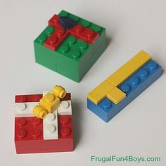 two legos sitting next to each other on top of a white table with red, yellow and green blocks