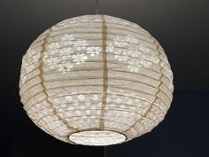 a white paper lantern hanging from a ceiling