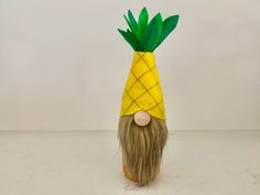 a fake pineapple with a beard and long hair