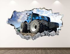 a large blue tractor is seen through the hole in this wall decal, which shows it's front end