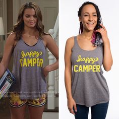 the young woman is wearing a happy camper tank top and her hair in braids