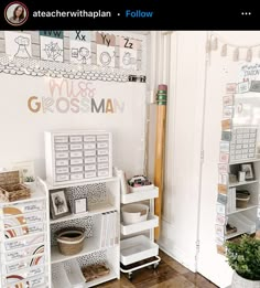 a room with lots of white shelves and baskets on the floor next to a door