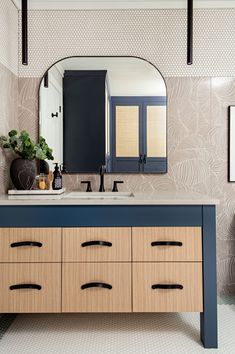 a bathroom vanity with two sinks and mirrors